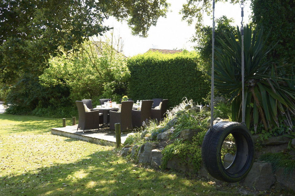 Tyre swing and dining table in garden